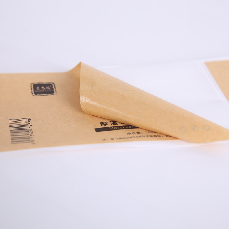Close-up of brown kraft label material and peel-up edge